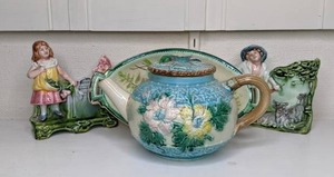 lot 35 image: Vintage Pottery Pieces Two Majolica Style GirlBoy Planters, Floral Serving Tray, Floral Teapot