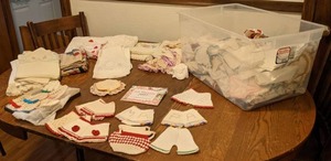 lot 660 image: Vintage Lot of Exquisitely Embroidered, Crocheted and Quilted Items Doll Clothes, Doilies, Pillowcases, Tea Towels and More