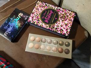 lot 415 image: Lot of (3) Womens Cosmetic Products - Laura Geller The Delectables Eye Shadow Palette, Urban Decay Moondust, Too Faced The Power of Makeup by Nikkietutorials