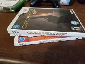 lot 438 image: Lot of (3) Wii Games - Goldeneye 007, Guitar Hero III Legends of Rock, Guitar Hero 5
