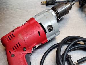 lot 83 image: Electric Milwaukee Drill and Skllisaw 7-14 Circular Saw