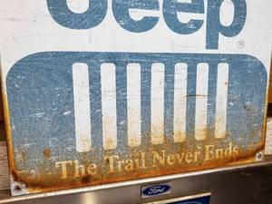 lot 250 image: Weathered Jeep Tin Sign