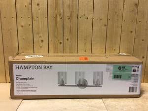 lot 75 image: Champlain 22.375 in. 3-Light Brushed Nickel Modern Bathroom Vanity Light with Clear Seeded Glass Shades by Hampton Bay Customer Returns See Pictures