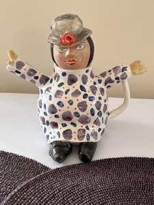 lot 94 image: Whimsical Character Pottery Teapot and Pair of Round Placemats