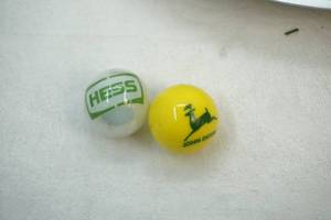 lot 307 image: John Deere and Hess marble shooters