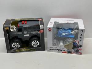 lot 2 image: New Motorized Monster Truck and New Thunder Tumbler Remote Control Spinning Car