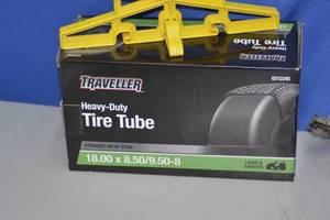 lot 24 image: Tire Tube, Minnkota Portable Charger, and cord wrap
