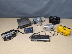 lot 681 image: Collection of (8) Vintage Cameras Canon Elph LT, Fusi 53000, Kodak Cx7430, Ultronic, Minolta 450Tx, Polaroid Spectra, Sports Illustrated, and Kodak X15 - V