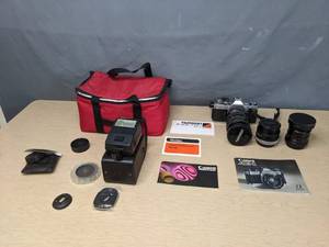 lot 684 image: Vintage Canon AE1 Camera with Light and (2) Lenses - V