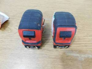 lot 103 image: (2) Milwaukee 25 Tape Measures.