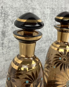lot 62 image: Two Czech Amber Glass Decanters with Floral Design- Irice Imports