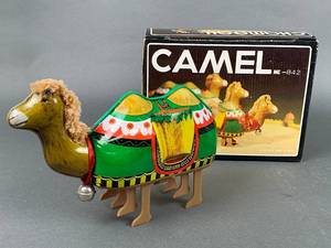 lot 142 image: Litho Tin Toy Walking Electric Camel, unopened Got a Minute Game & Czech Beruska Lady Bug.