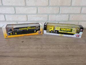 lot 909 image: 1964 Ford C-950 Semi Truck w 1966 Mustang and 1969 Dodge L600 Semi Truck w 1969 Dodge Charger Daytona 440 - M2 Machines Diecast 164 Scale - Comes in Hard Plastic Display Cases