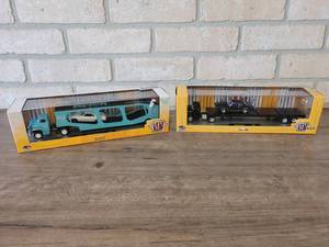 lot 910 image: 1958 Chevrolet Spartan Semi Truck w 1968 Pontiac Firebird and 1958 Chevrolet LCF Semi Truck w 1969 Pontiac GTO - M2 Machines Diecast 164 Scale - Comes in Hard Plastic Display Cases