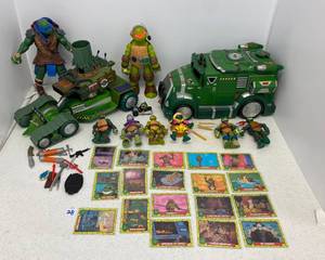 lot 28 image: Group Of TMNT Action Figures, Vehicles And 1989 Trading Cards