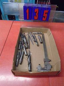 Flat of drill & mill bits with vintage 10 starrlet caliper. As shown.