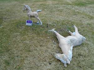 Qty of 2 cement horses. One is taking a nap. As shown.