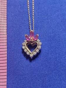 lot 205 image: Gold 14K ruby and diamond heart Necklace chain is broken