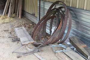 lot 1065 image: Lot of (8) Vintage Wagon Parts - (7) Wagon Wheel Outer Rims, (1) Wagon Seat