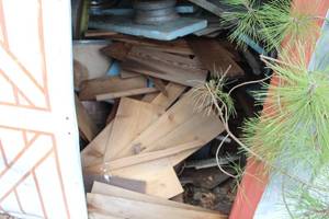 lot 1079 image: Contents of Shed - Scrap Wood, Car Rims, Spare Tires, Misc. Items