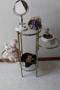 lot 1793 image: Decorative Metal Display 4-tier with Glass Shelves with Vanity Table Mirror, Statue, Doll, Floral Arrangement, Angel Bowl