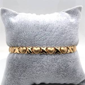 lot 39 image: Treasurable Moments XOXO Hearts Hugs & Kisses Bracelet in Satin & Bright Shine Yellow Gold Estate