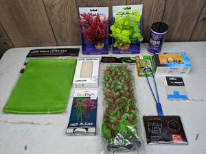 lot 481 image: New Aquarium Supplies Aqualife 8 Plants, Fluval Ammonia Test Kit, Aquatop Vera-Life Decor, Omega One Small Cichlid Pellets, & More