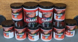 lot 655 image: NEW 12 Containers Omega One Super Color Flakes, (10) .42 oz. & (2) 2.2 oz. Sizes