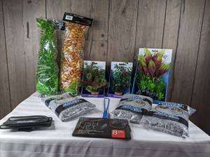 lot 1279 image: Assortment of New Plant Scapes, Fishing Net, Python Porter, and Stoney River Premium Sand