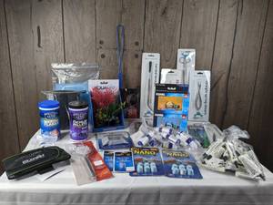 lot 1283 image: Large Assortment of New Aquarium Accessories (Weasel Fat Silicone Lubricant, Phosphate Test, Water Hardener, and more)