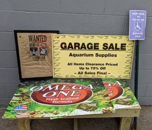 lot 1490 image: 5-Piece Lot of Signs (2) Omega One Fresh Seafood Formula, Handicap Parking, Wanted Lionfish, and Garage Sale Sign