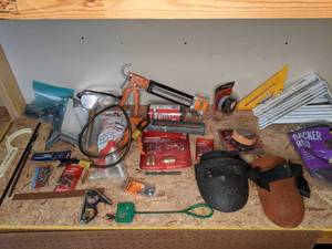 lot 1373 image: Assortment of Miscellaneous Tools (7) Shelf Brackets, Husky 14in. Hose Repair Kit, Caulk Gun, Oil Filter, Headlight Restoration, Patching Fabric and More