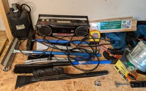 lot 1516 image: More Garage Goodies Flotech Submersible Pump, Boombox, Ice Scraper, Squeegee, Saw Blades, and More