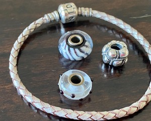lot 444 image: Pandora Leather Necklace and Leather Bracelet and Three Beads