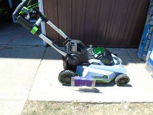 E-Go 56 volt cordless lawn mower. Looks nearly new but wires have been cut. No battery or charger. As shown.