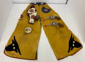 lot 68 image: Vintage Kids Cowboy Chaps and Leather Cap Gun Holster With Two Cap Guns