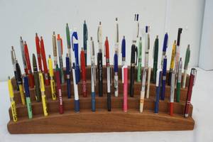 lot 126 image: wood pen holder with bag of pens