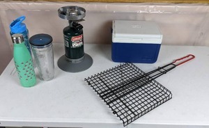 lot 215 image: Coleman Camping Supplies Cooler, Propane Fuel, Folding BBQ Grilling Basket, and Reusable Water Bottles