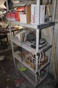 lot 642 image: Contents of Shelving Unit - Fram FT1074 Transmission Filter, Brake Caliper, Brake Pads, Automotive Books, Misc. Items