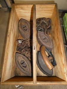 wood box with 4 sad irons