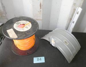 Big spool of weed whip string and garden hose hanger