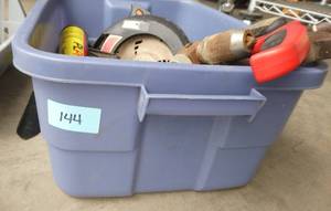Tote full of tools, circular saw, hand saws, and more