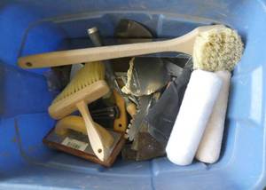 Tote full of sheetrocking and painting supplies and a floor drain