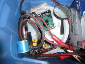 Tote full of garage items - floodlights, jumper cables, fishing line, magnifier, wire, etc