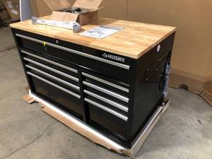 lot 12 image: Husky 52 in. W x 25 in. D Standard Duty 9-Drawer Mobile Workbench Tool Chest with Solid Wood Top in Gloss Black - Has Damage - Review all pictures