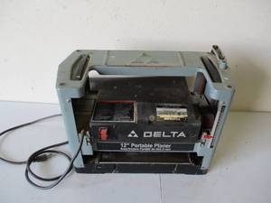 lot 12 image: Delta 12 Portable Planer with Manual. Model 22-540.