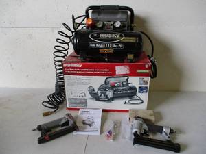 lot 91 image: Husky 2 Gallon Dual Output Compressor & Brad Paslode Nailer Kit in box. Works.