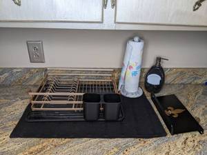 lot 266 image: Assortment of Kitchen Accessories Rose Gold Dish Rack, (2) Drying Mats, Marble Paper Towel Holder, Soap Dispenser and More