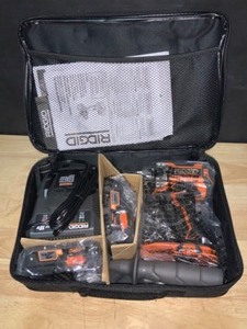 lot 30 image: RIDGID 18V Brushless Cordless 12 in. Hammer DrillDriver Kit with (2) 4.0 Ah MAX Output Batteries, 18V Charger, and Tool Bag. See Pictures