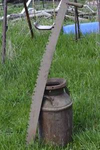 lot 42 image: Milk can with 2 person saw